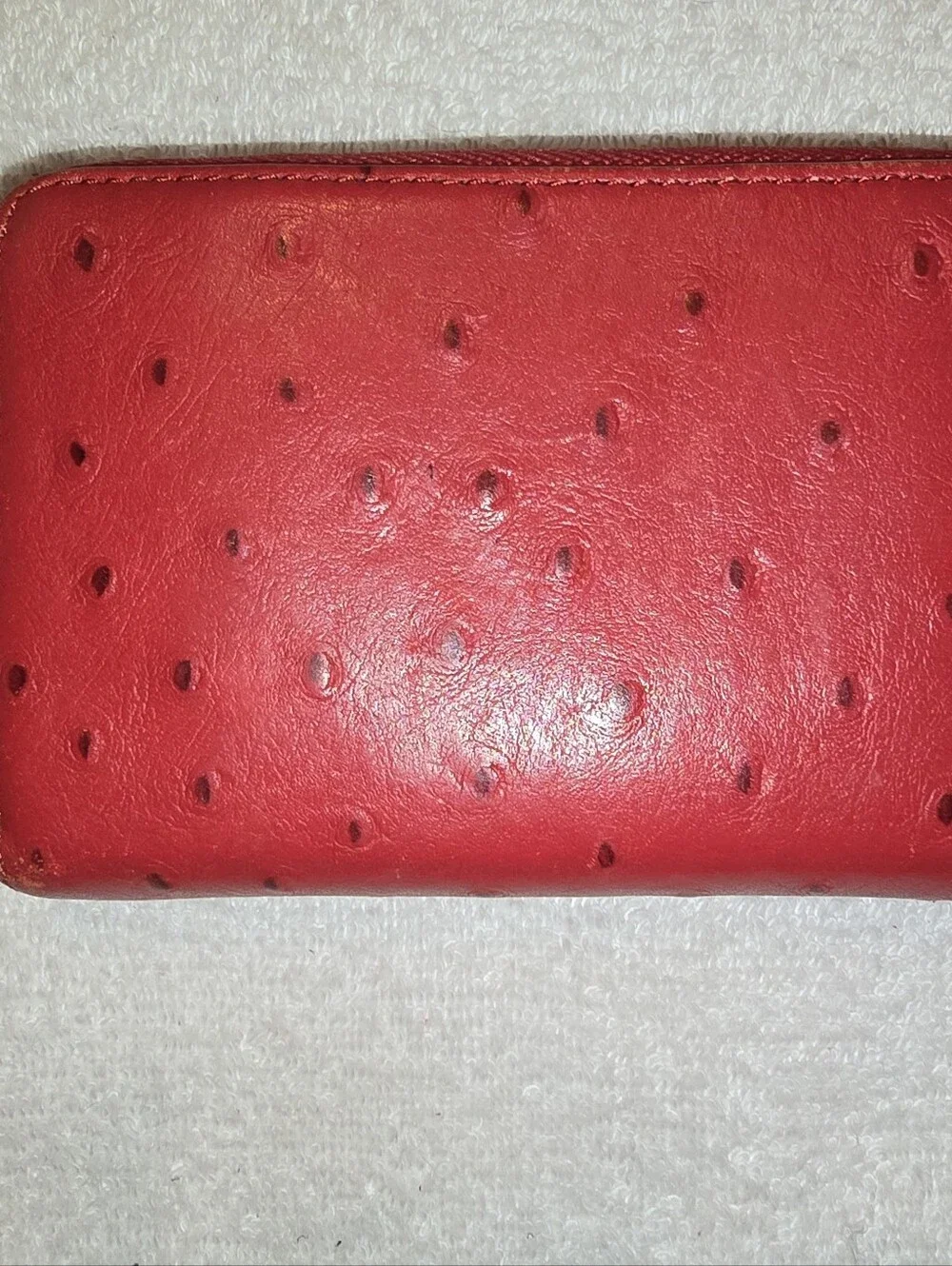 Michael Kors Red ostrich-patterned zip-around wallet featuring 1981 Goldtone